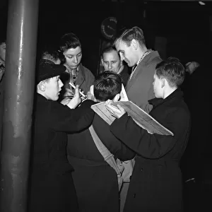 Sunderland footballer Don Revie signing autographs for young fans