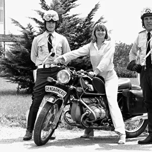 Susan Penhaligon, film actress July 1977 borrows a motorbike from two gendarmes during a