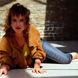 Susan Tully lying on ground wearing suede jacket 1989