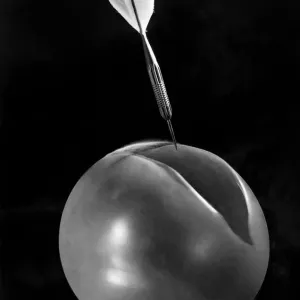Swiftly. The cut divides the flimsy toy, while the dart is poised above Swiftly. The cut divides the flimsy toy, while the dart is poised above