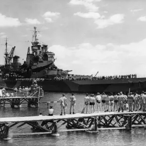 Swimming club visitors gather on the diving boards to watch the passage of the Royal Navy Swimming club visitors gather on the diving boards to watch the passage of the Royal Navy