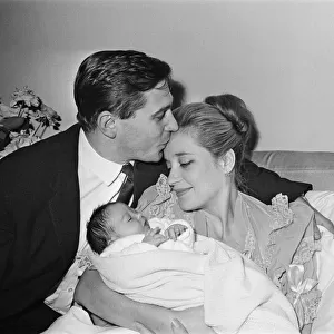 Sylvia Syms, actor and star of Ice Cold In Alex, with her new born baby daughter Beatrice