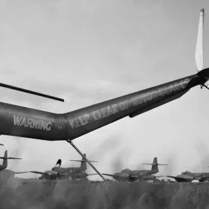 The tail of a Bristol Sycamore frames a flight of Meteors ready for take off at RAF The tail of a Bristol Sycamore frames a flight of Meteors ready for take off at RAF