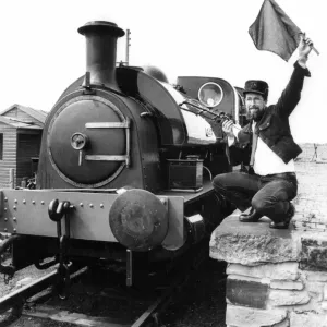 Tanfield Railway Association guard Bob Payne flags away the newly-commissioned Hawthorn