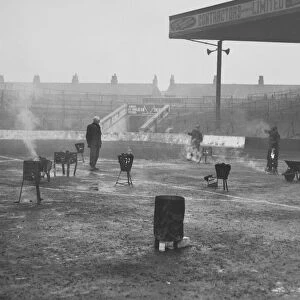 A team of four men thaw out Manchester City Football ground with braziers