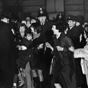 Teenage fans of The Beatles pop group try to break the police cordon as the band leave Teenage fans of The Beatles pop group try to break the police cordon as the band leave