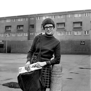Teenage girl from Toxteth in Liverpool delivering newspapers on a paper round