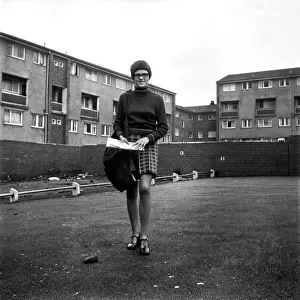 Teenage girl from Toxteth in Liverpool, Merseyside, delivering newspapers on a paper