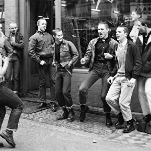 Teenage Skinheads dancing the Moonstomp outside a shop in London. 29th March 1980