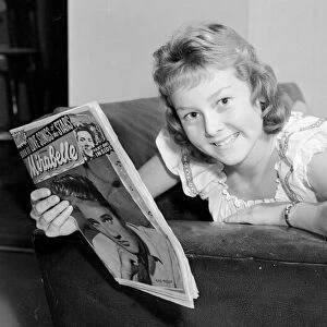 Teenager Lesley Woods reading the Mirabelle magazine October 1959