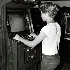 Teenager playing arcades - July 1983 14 year old Ian Pollard in Amusement Arcade in