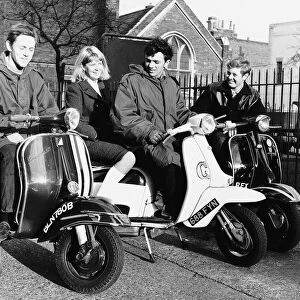 Teenagers following Mod fashion on scooters