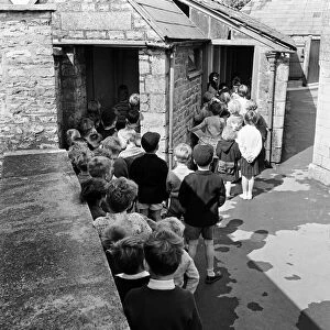 Tetbury primary school, Gloucestershire. Children queuing for the toilet during break