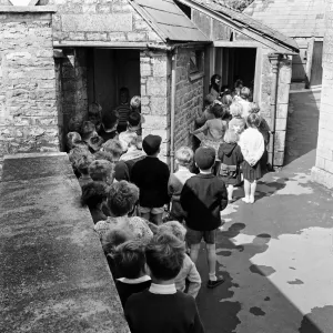 Tetbury primary school, Gloucestershire. Children queuing for the toilet during break Tetbury primary school, Gloucestershire. Children queuing for the toilet during break