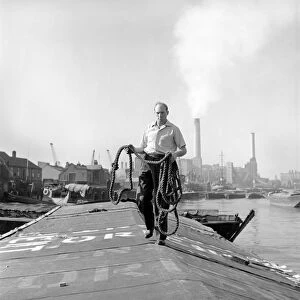 Thames barge man Ernest Murray seen here at work on the river. Circa 1960