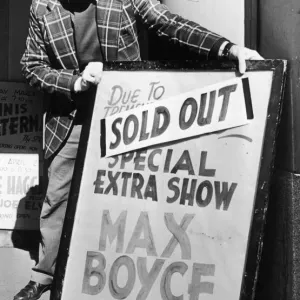Theatre worker Ted Grant places the sign outside the Coventry Theatre telling the bad