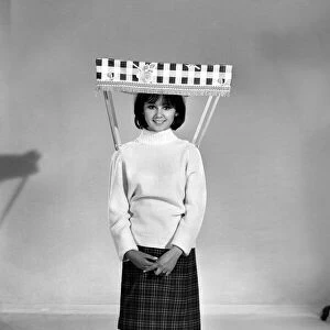 Therese Howard Jones demonstrating the wear-me umbrella. Model. Circa 1959