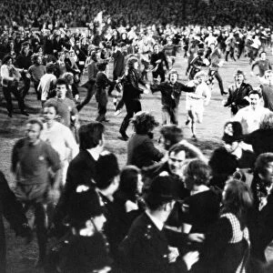 Thousands of Birmingham City fans swarm onto the pitch after their team clinched