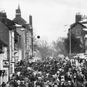 Thousands of villagers line the streets of Atherstone for the traditional Shrove Tuesday