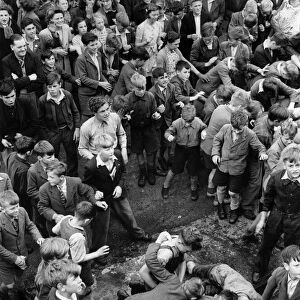 Throwing hot pennies to children at Honiton Fair, Devon. August 1943