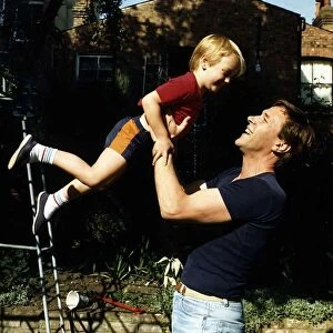 Timothy Bentinck Actor playing with his son Will Bentinck in his garden at home