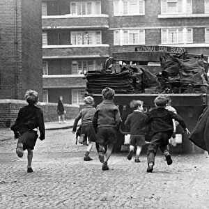 Toddlers in Merseyside running after National Coal Board Lorries and trying to jump