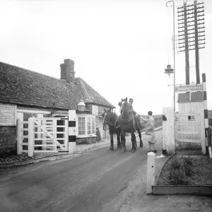 The toll is taken from a farmer and his team of two shire plough horses at the Swinford The toll is taken from a farmer and his team of two shire plough horses at the Swinford