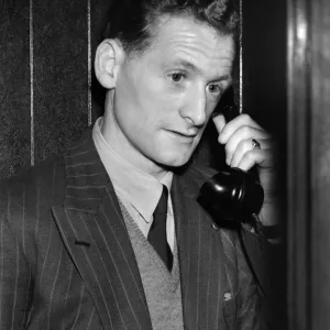 Tom Finney, who plays on the right wing, seems worried as he makes a midnight phone call