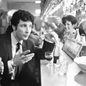 Tom Jones, enjoys a drink, 22nd February 1965