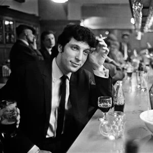 Tom Jones enjoys a drink. 22nd February 1965