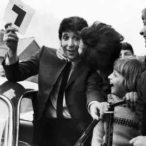 Tom Jones gets a kiss from a fan as he passes his Driving Learners test at Newport