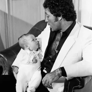 Tom Jones with his grandson Alexander, aged eleven months, in their London hotel