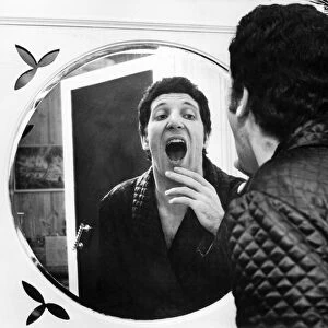 Tom Jones, singer from Wales, pictured circa 1965, examining his famous tonsils in