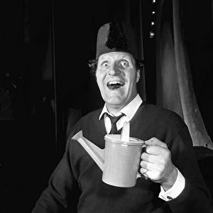 Tommy Cooper comedian wearing fez hat June 1965 and holding toy watering can