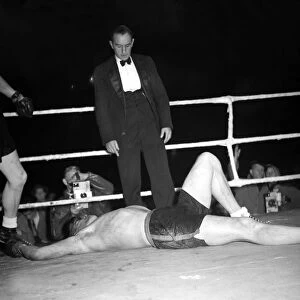 Tommy Farr looks down on his opponent Jan Klein when they met 27 / 9 / 1950