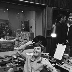 Tony Blackburn, the 22 year old Disc Jockey, finishes his broadcast of the very first
