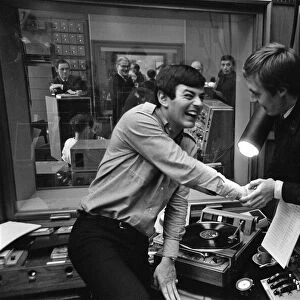 Tony Blackburn, the 22 year old Disc Jockey, finishes his broadcast of the very first
