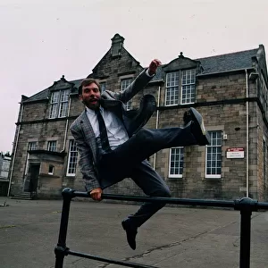 Bill Torrance - Singer TV Presenter jumping over fence at Broxburn Primary