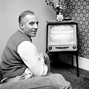 Tottenham Hostpur footballer Eddie Bailey at home watching a match on the television
