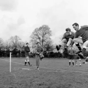 Tottenham Hotspur players Terry Dyson and Les Allen jumping over the rope in training Tottenham Hotspur players Terry Dyson and Les Allen jumping over the rope in training