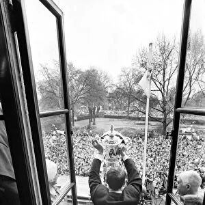 Tottenham Hotspur team hold the FA Cup trophy aloft at Tottenham Town Hall to a crowd of