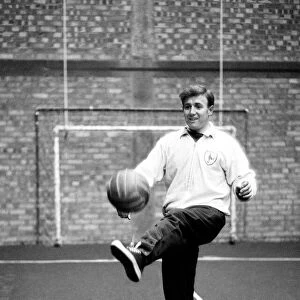 Tottenham Hotspur winger Terry Medwin practices his ball skills as he trains alone at