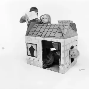 Toys: Children playing with a Wendy house made out of cardboard Toys: Children playing with a Wendy house made out of cardboard