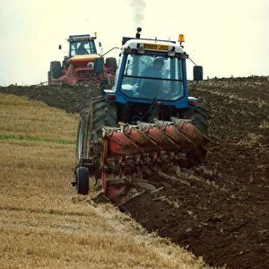 Tractors ploughing up a field