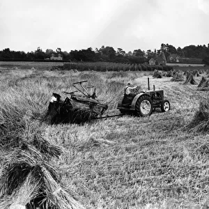 Tractors at work during a harvesting scene in England. Circa 1970 P004513