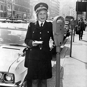 Traffic Warden, Denise Taylor, looks at a parking meter in London. August 1973 P018265