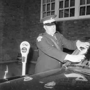 Traffic warden during training sticking fine on window screen parking clock