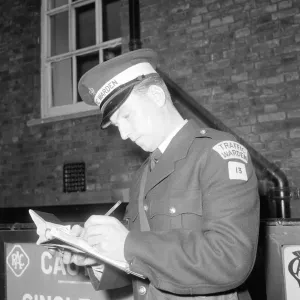 Traffic warden during training writing a fine fining uniform