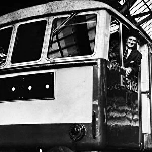 A train driver poses in the cab of his British Rail express Class 86 electric locomotive