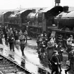 Trainspotters at railway station making notes on one of the steam locomotives, April 1961